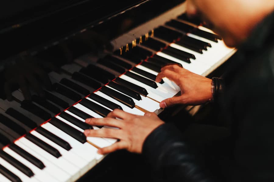 Hands playing a chord on piano keys