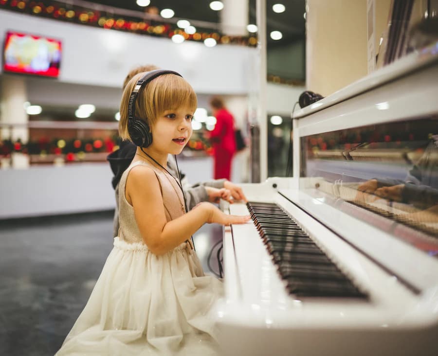 Young girl in headphones smiling at a white piano