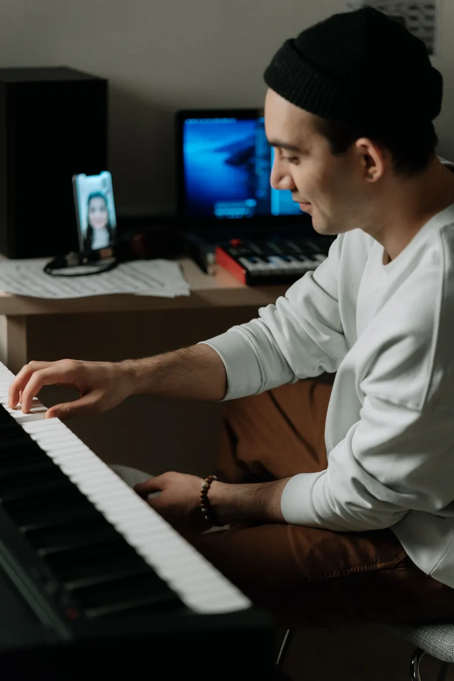 Young man playing piano during a video call lesson